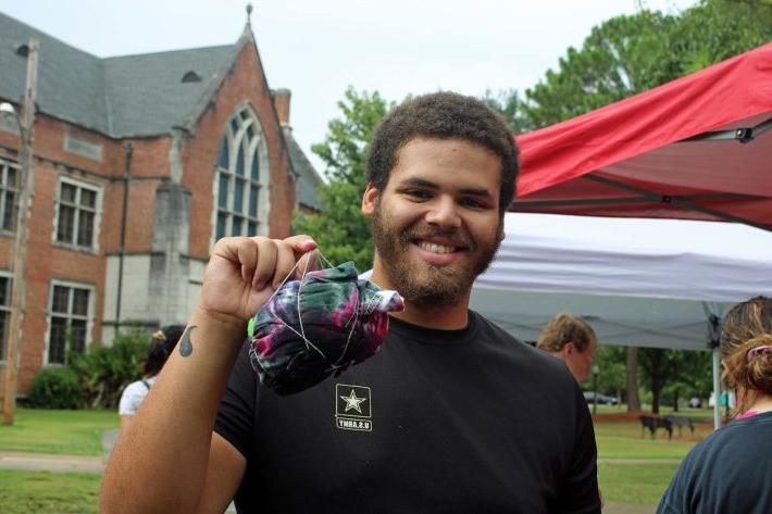 student holding tshirt